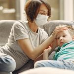 Parent wearing mask to prevent catching COVID19